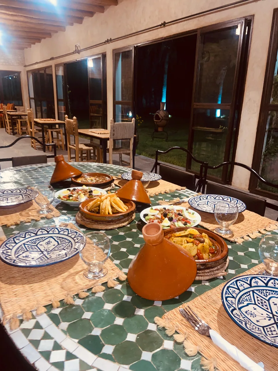 Tagines and Moroccan dishes set for dinner on the terrace at Riad Dar Ayman Essaouira